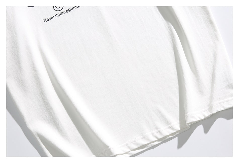 Close-up of the lower front and hem of a white shirt, with a small portion of black print visible near the top.