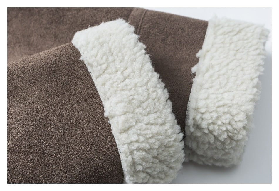 Close-up of thick cream fleece trim at the edge of the brown jacket sleeve and body.
