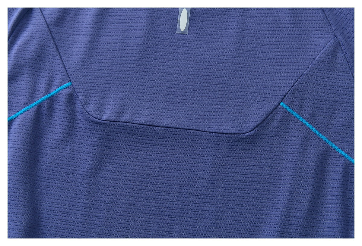 Close-up of the blue shirt's back panel seams with contrasting turquoise stitching.