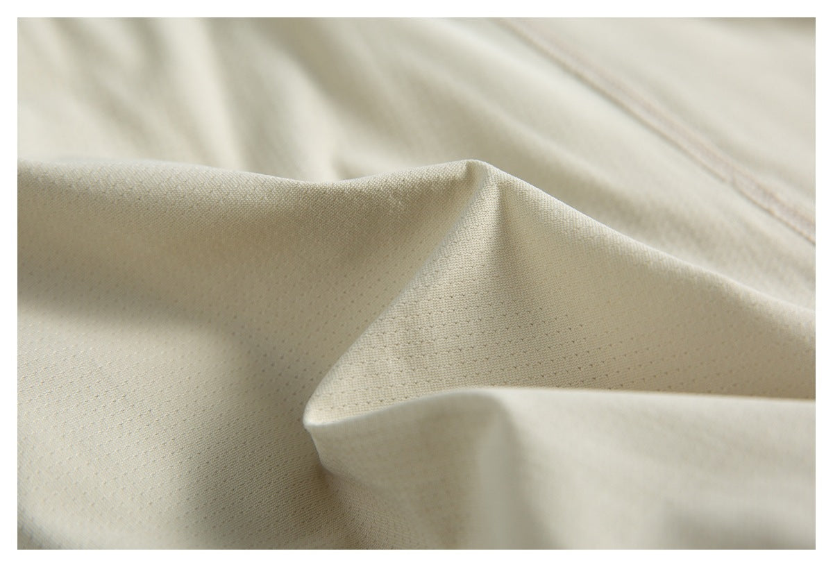 Close-up of ivory fabric folds highlighting a subtle woven texture.