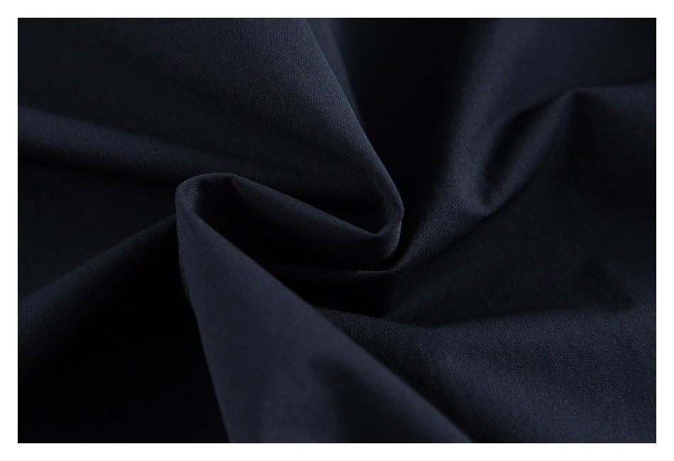 Close-up of dark navy fabric draped into soft folds.