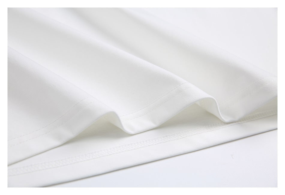 Close-up of the white T-shirt's folded hem and stitching.