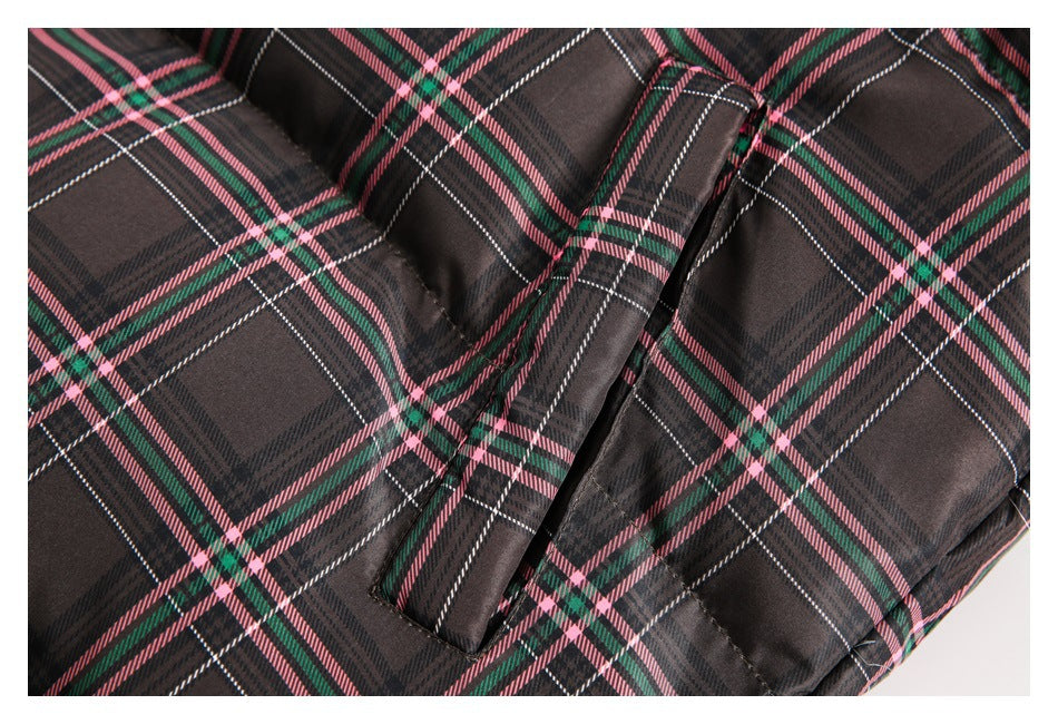 Close-up of a narrow pocket opening on the dark plaid jacket.