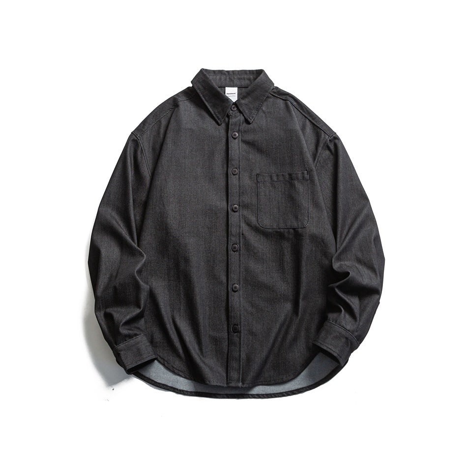 Black long-sleeve button-front shirt with chest pocket and curved hem, flat lay front view