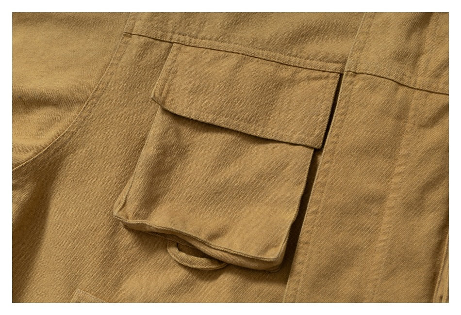 Close-up of a large flap pocket and stitching on the ochre jacket.