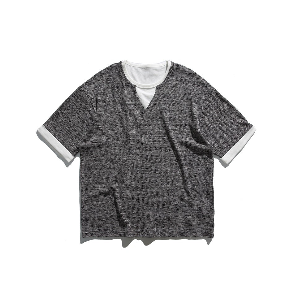 Black heathered short-sleeve tee with white inner neckline layer, V notch and white turned-back cuffs, flat lay