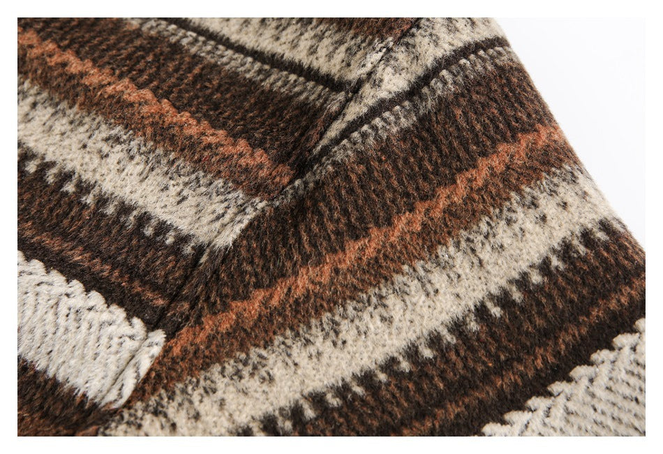 Close-up of a brown, rust, cream, and dark plaid garment with a visible seam and textured surface.