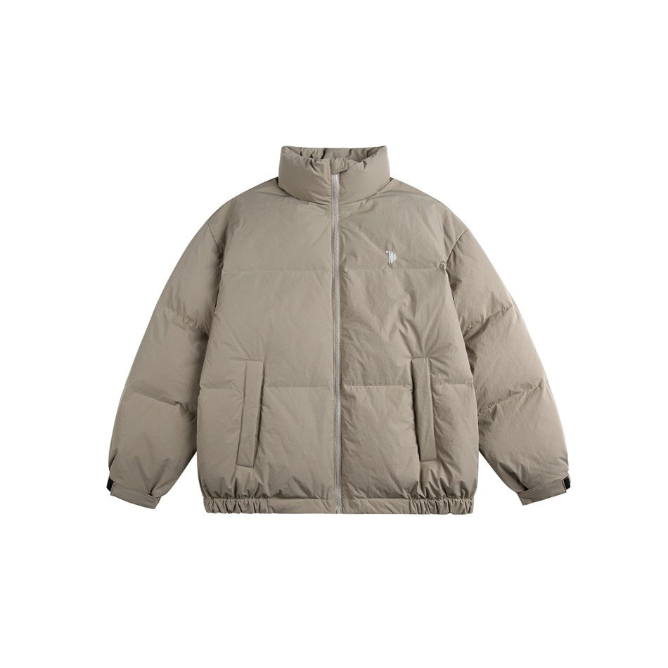 Gray puffer jacket flat lay with stand collar, front zipper, two front pockets and elastic hem