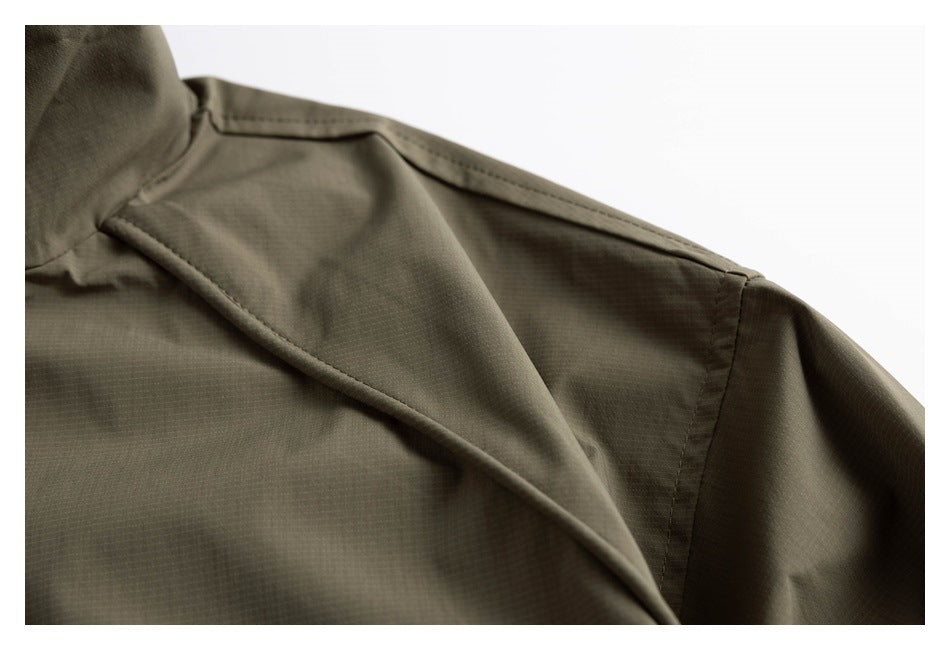 Close-up of an olive jacket’s collar, shoulder seam and front lapel.