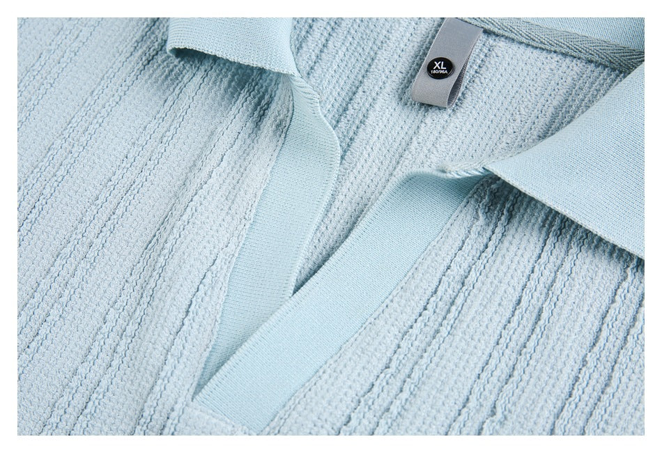 Close-up of a pale blue polo shirt collar, placket, and XL size label.