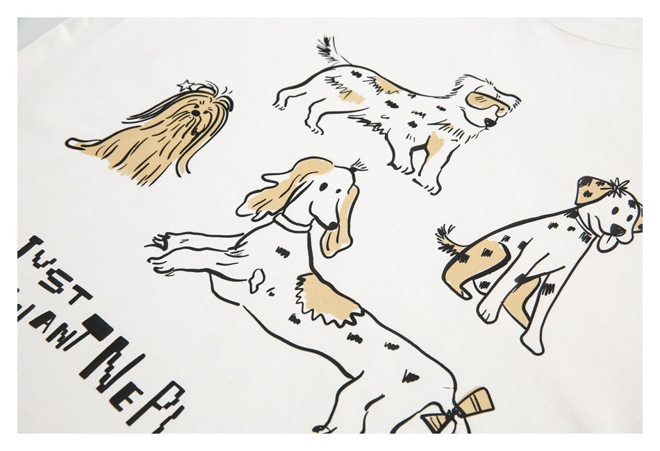 Close-up of a white shirt printed with several cartoon dogs in black and tan.