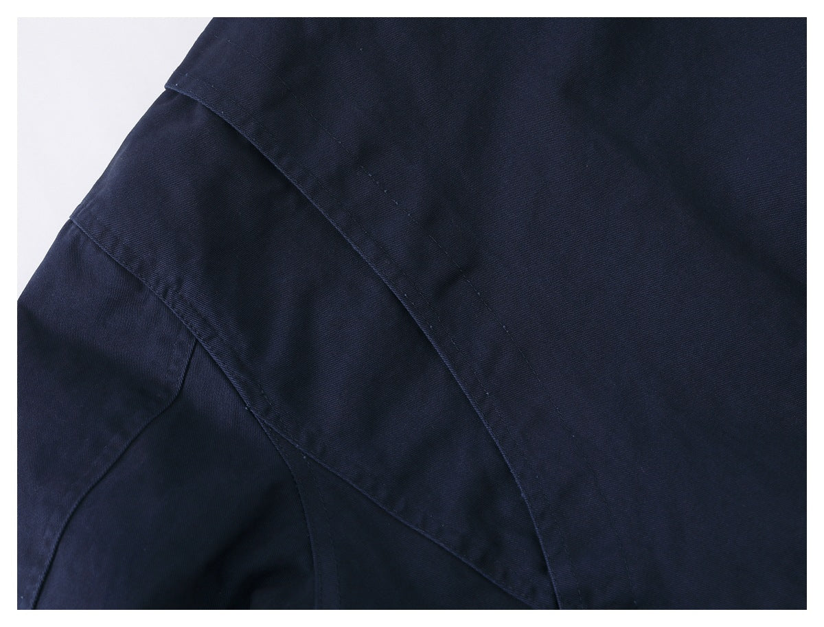Close-up of dark navy garment panels and curved stitched seams.