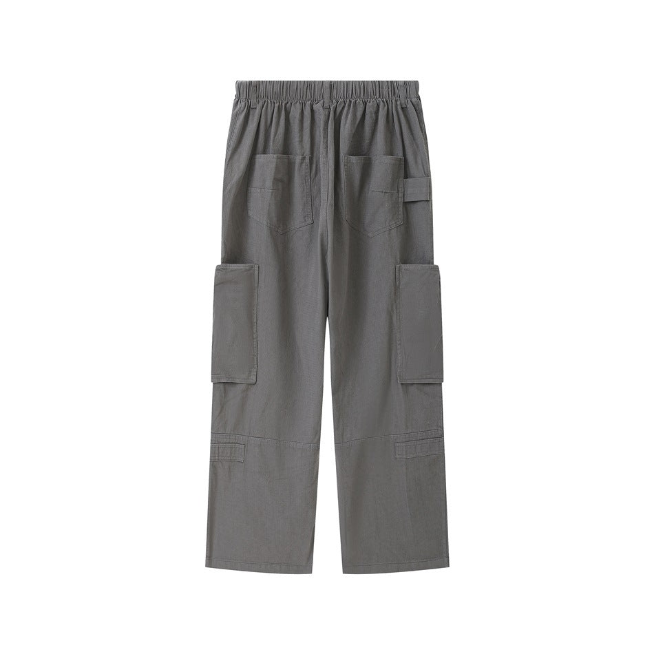 Back view of charcoal-gray wide-leg cargo pants with an elastic waistband, back pockets, and large cargo pockets.