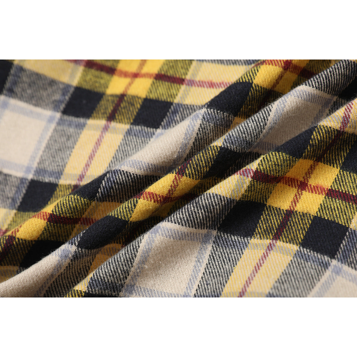Close-up of folded plaid fabric in yellow, gray, cream, and black.