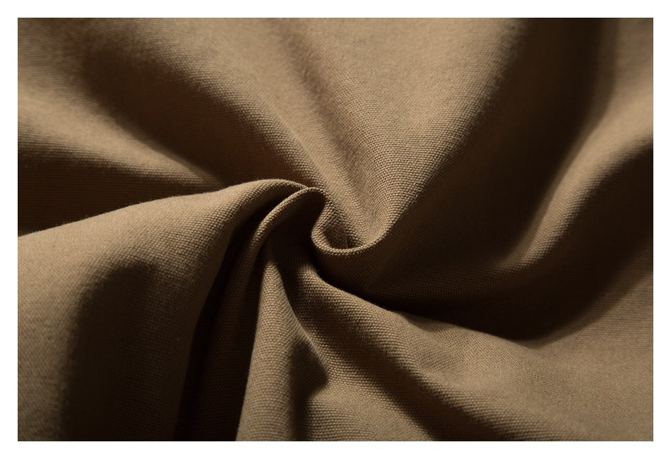Extreme close-up showing the woven texture and folds of tan-brown fabric.