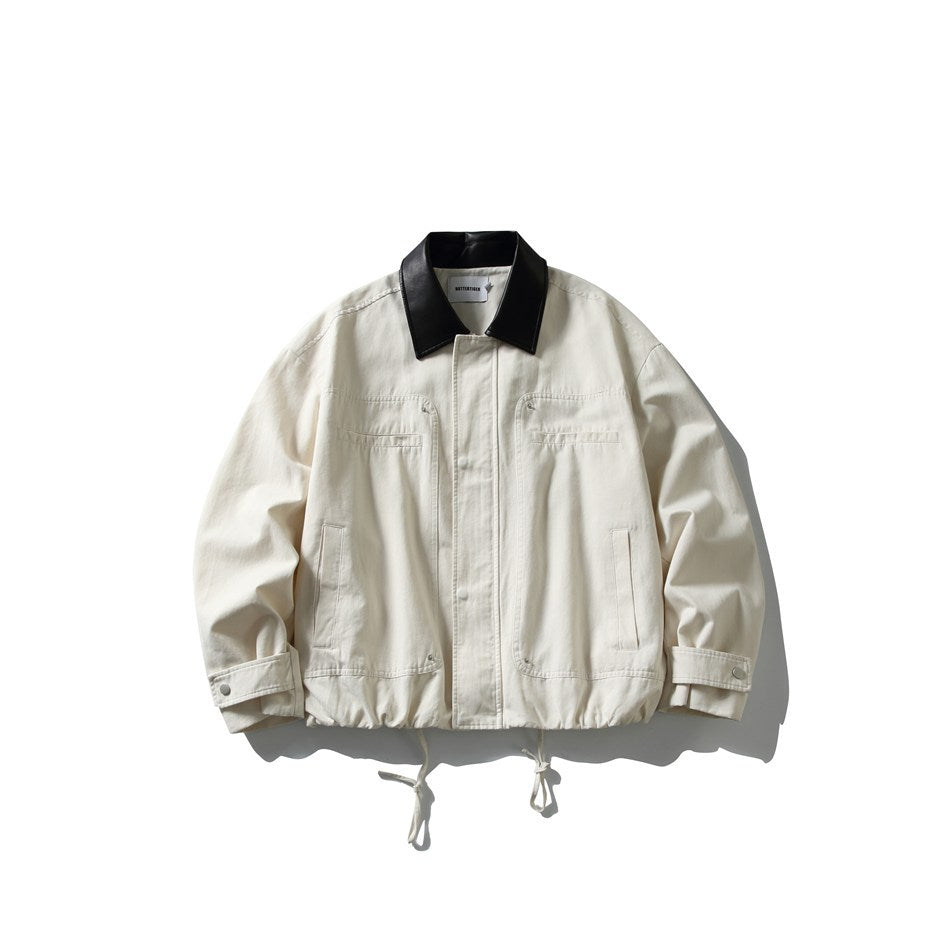 Off-white jacket with black contrast collar, front placket, chest and side pockets, cuff snaps and drawstring hem, flat view