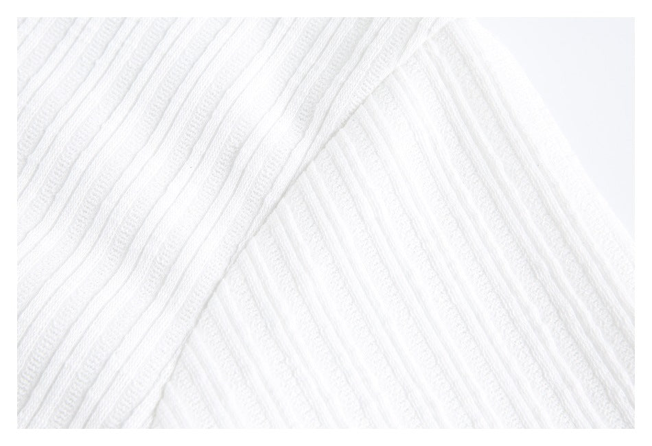 Close-up of the white shirt's ribbed fabric and a diagonal seam.