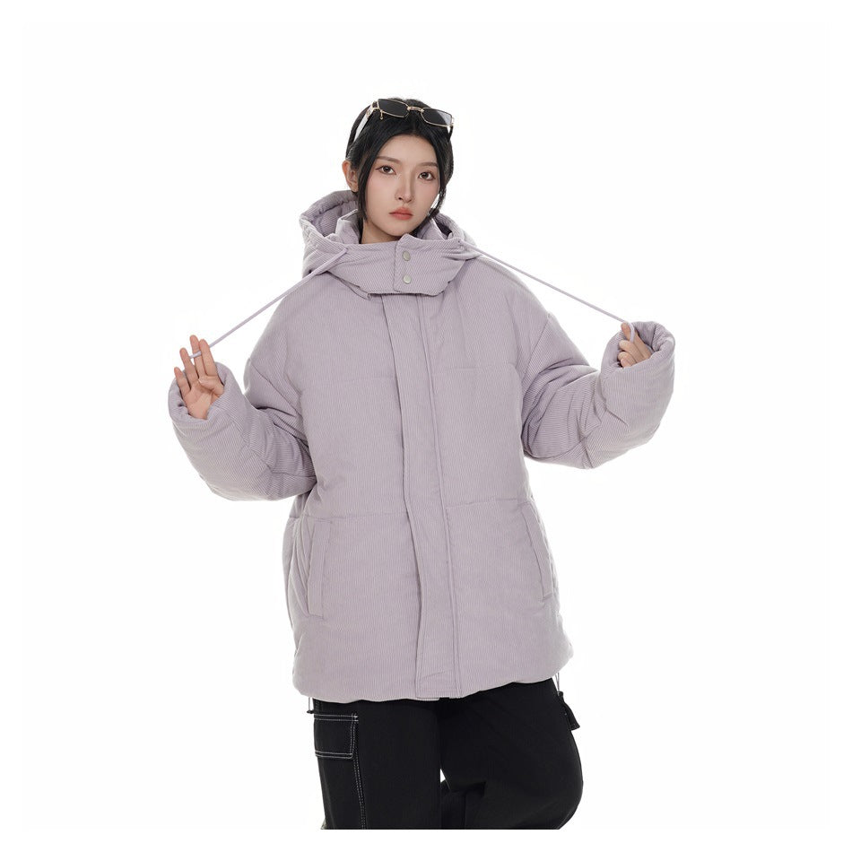 Model wearing a pale lavender hooded padded jacket and holding its long hood drawstrings out to the sides.