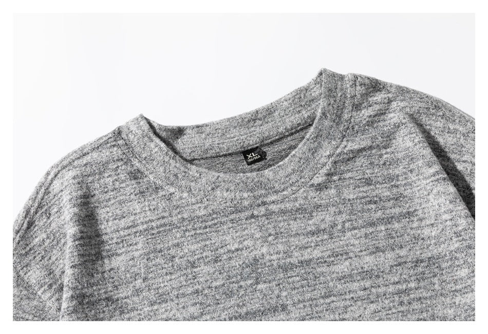 Close-up of the gray marled shirt's crew neckline and inside neck label.