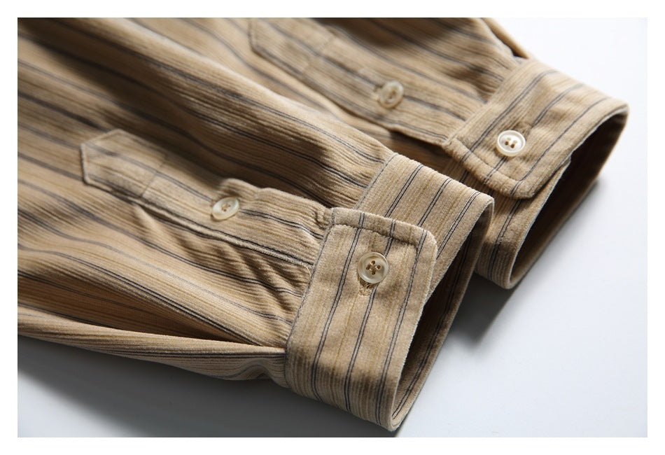 Close-up of two buttoned cuffs on a beige shirt with fine brown and gray stripes.
