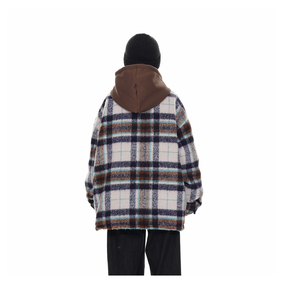 Rear view of a person wearing a white plaid hooded jacket with navy, brown and turquoise lines, black pants and a black