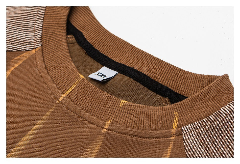 Close-up of a brown striped crew neckline with ribbed trim and a 2XL size tag.