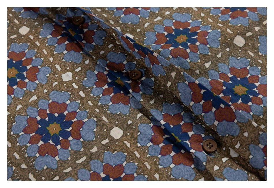 Close-up of a brown shirt's button placket and buttons amid blue and rust floral geometric print.