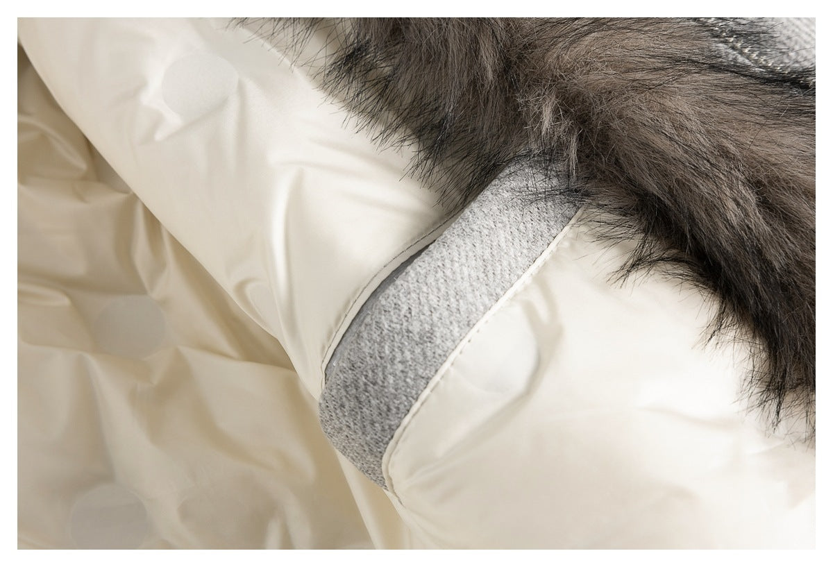Close-up of the coat's cream lining, gray fabric trim, and dark fur edge.