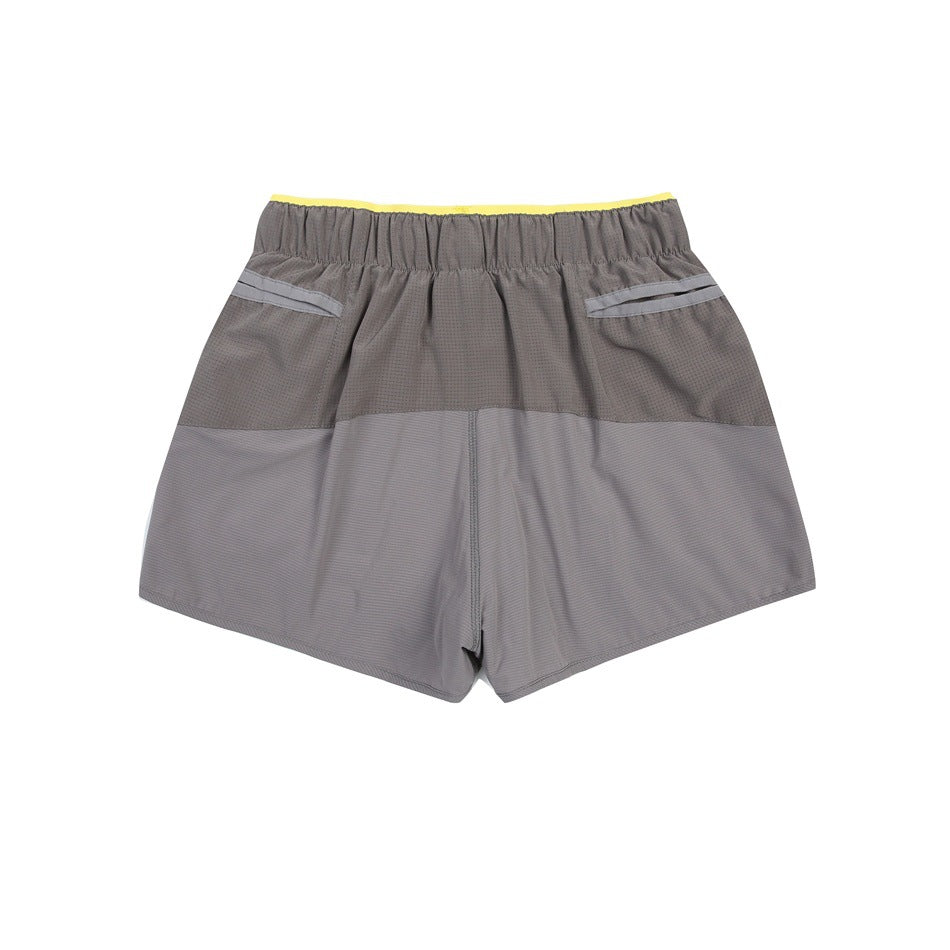 Back view of gray shorts laid flat, with a yellow-accented elastic waistband and two rear pockets.