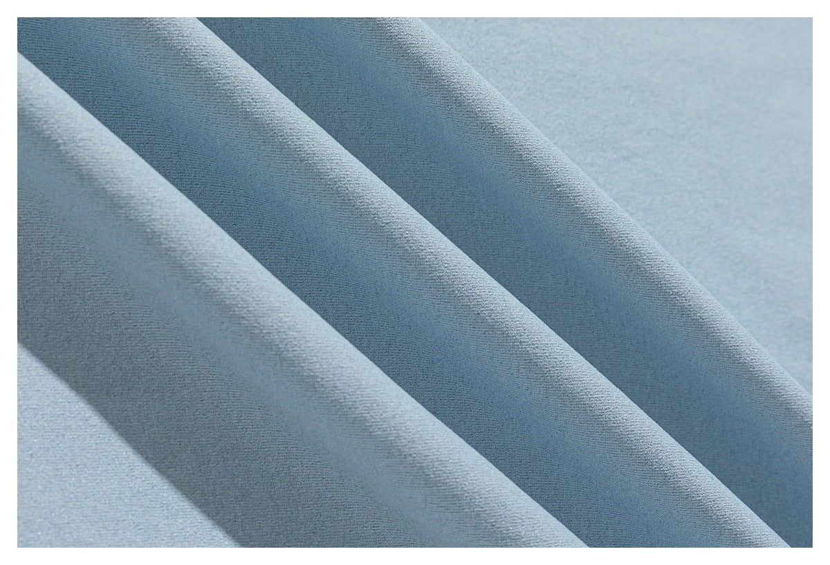 Close-up of pale blue fabric with a fine, even texture and soft diagonal folds.