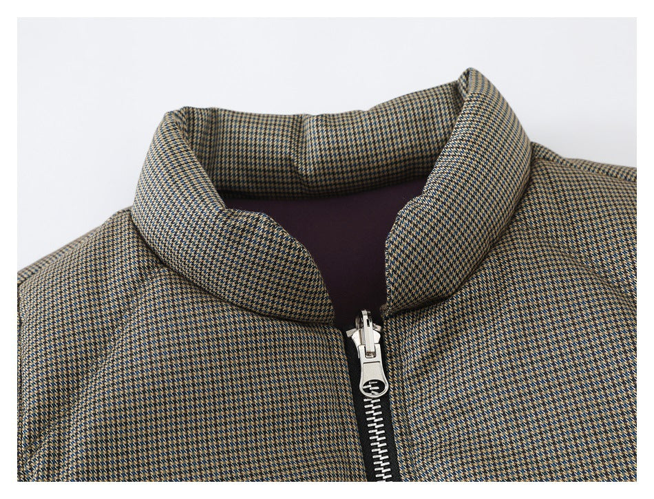 Close-up of a tan, navy, and cream patterned jacket collar and silver front zipper.