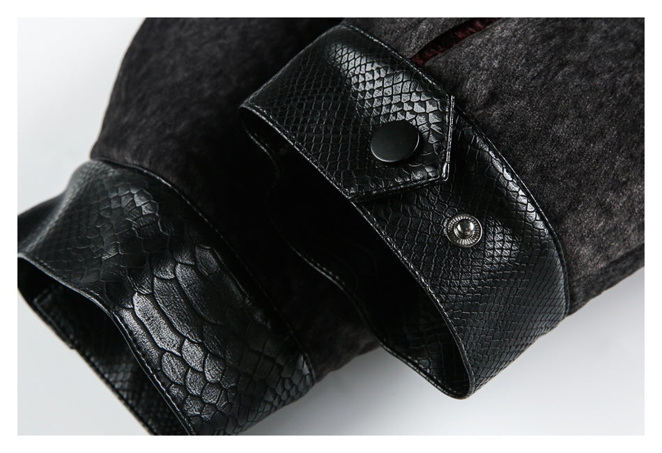 Close-up of a jacket cuff with glossy black reptile-textured trim and snap closures.