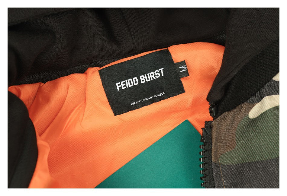 Close-up of the jacket’s black neck label against bright orange lining and camouflage fabric.