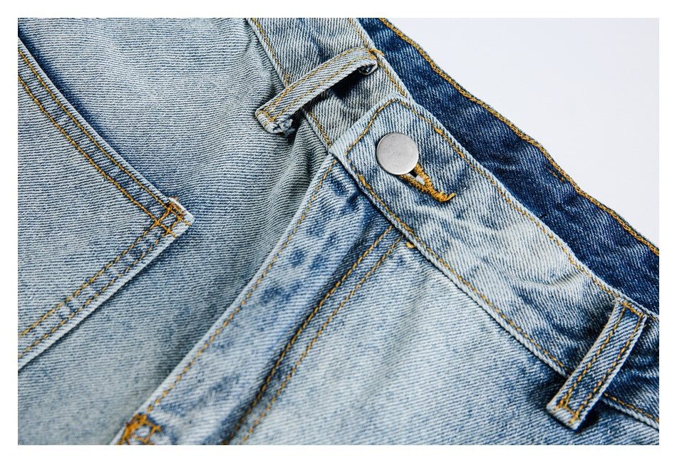 Close-up of light-wash jeans waistband with metal button, belt loop, and pocket stitching.