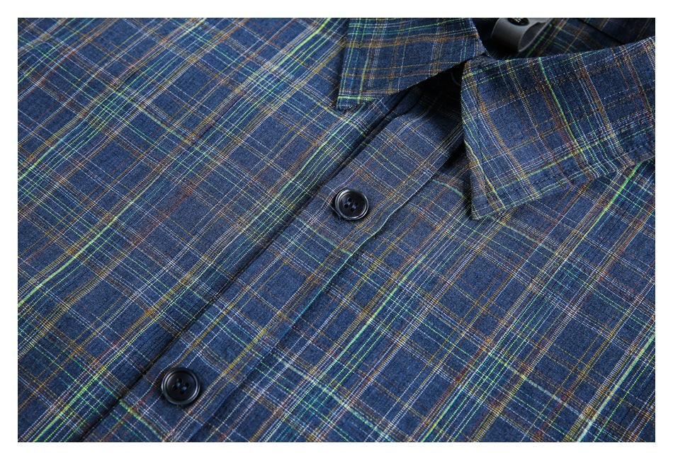 Close-up of a blue plaid shirt collar and button placket with dark buttons.