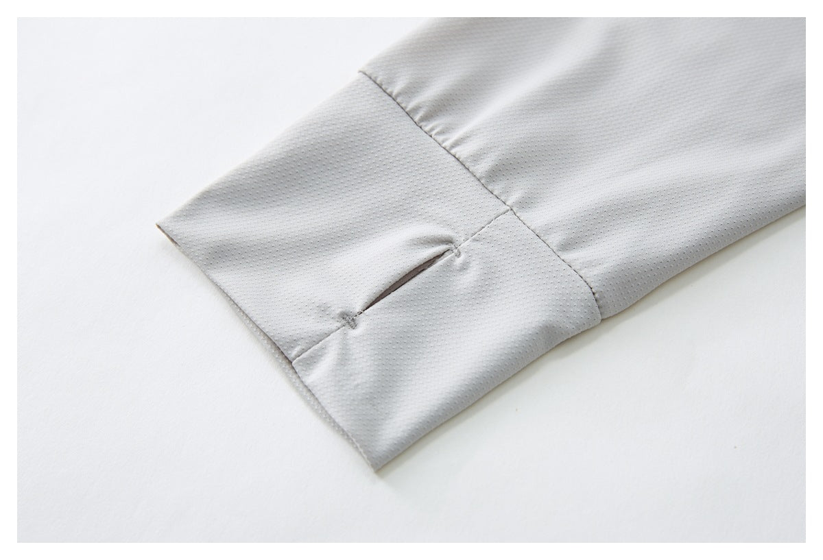 Close-up of a small slit opening at the cuff of a light gray perforated sleeve.