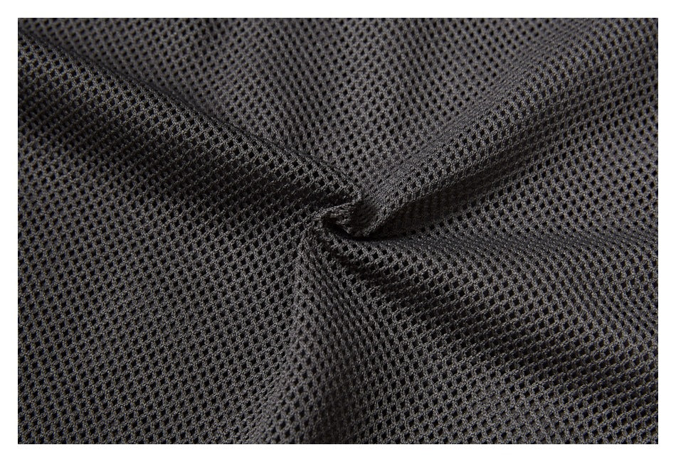 Macro view of the dark garment's open-weave mesh lining.