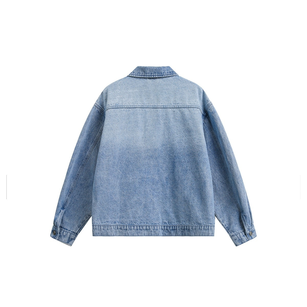 Back view of a light blue denim jacket laid flat, with long sleeves, a yoke seam and buttoned cuffs.
