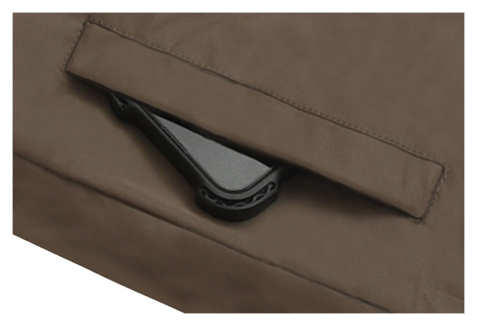 Close-up of a brown jacket pocket flap with a dark fastening beneath it.