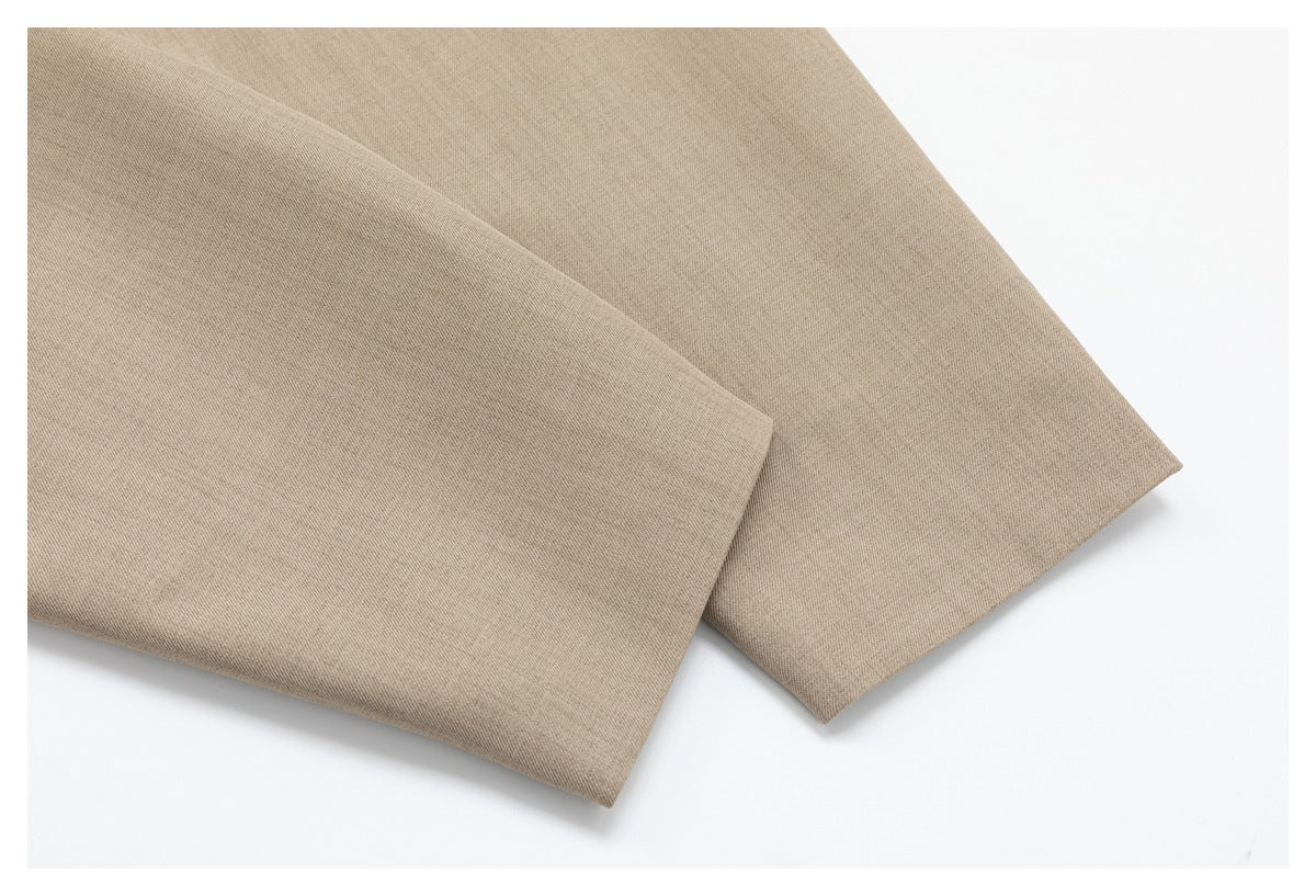 Folded beige fabric shown on a white background, with a smooth surface and visible fine weave.