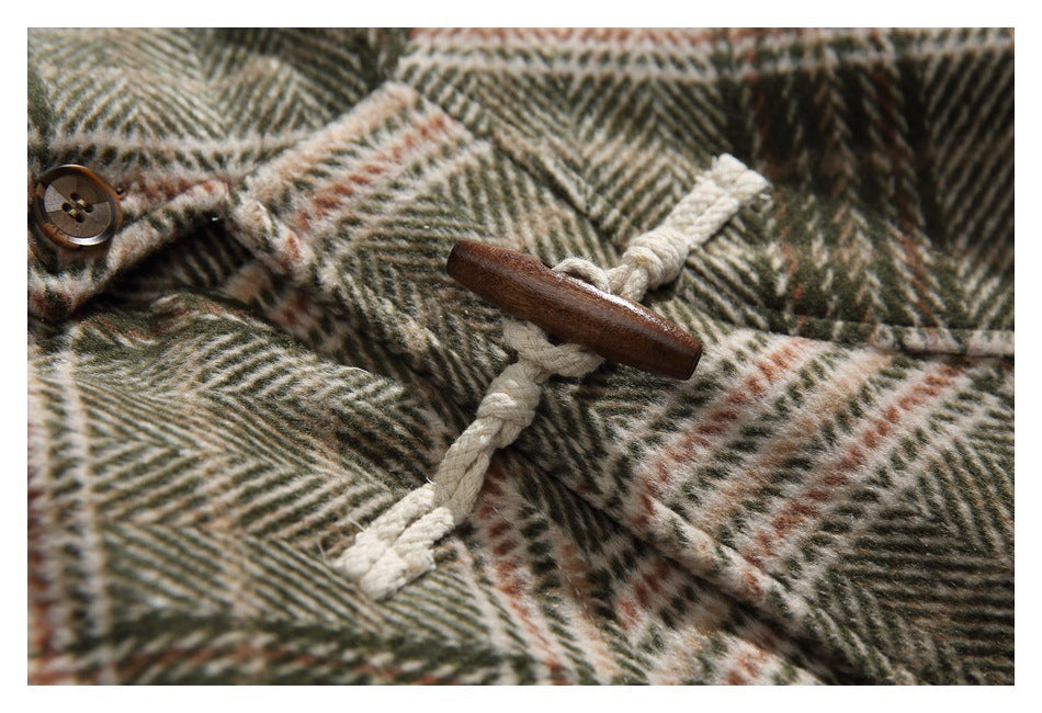 Close-up of a wooden toggle and cream rope loop on the coat's plaid fabric.