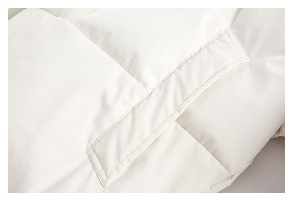 Close-up of stitching and panel seams on the ivory padded jacket.
