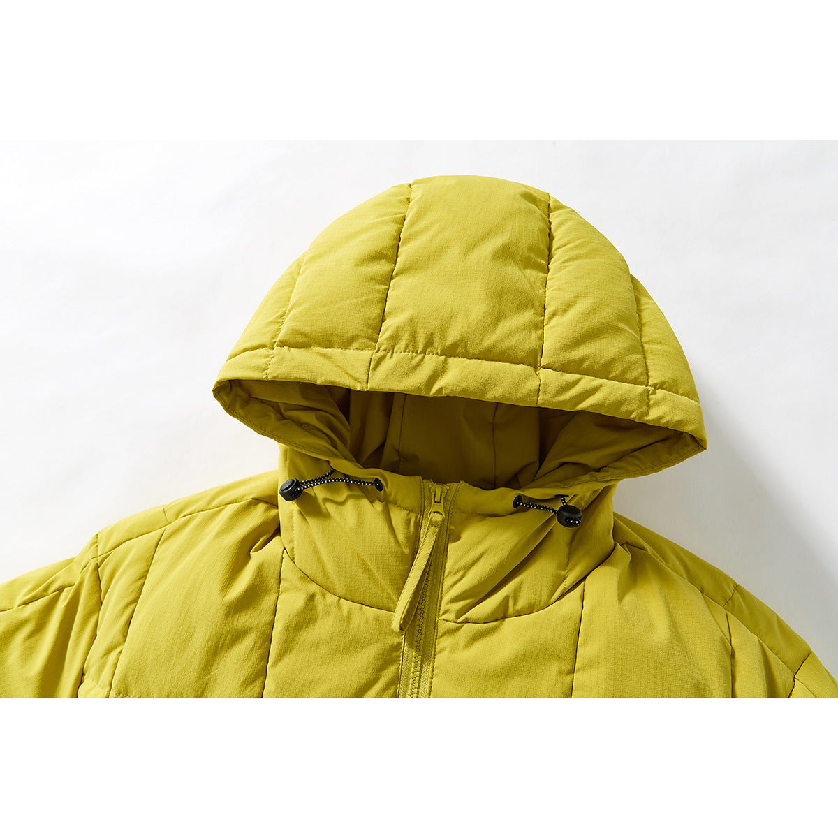 Close-up of a yellow quilted jacket hood, drawcord toggles, and front zipper.