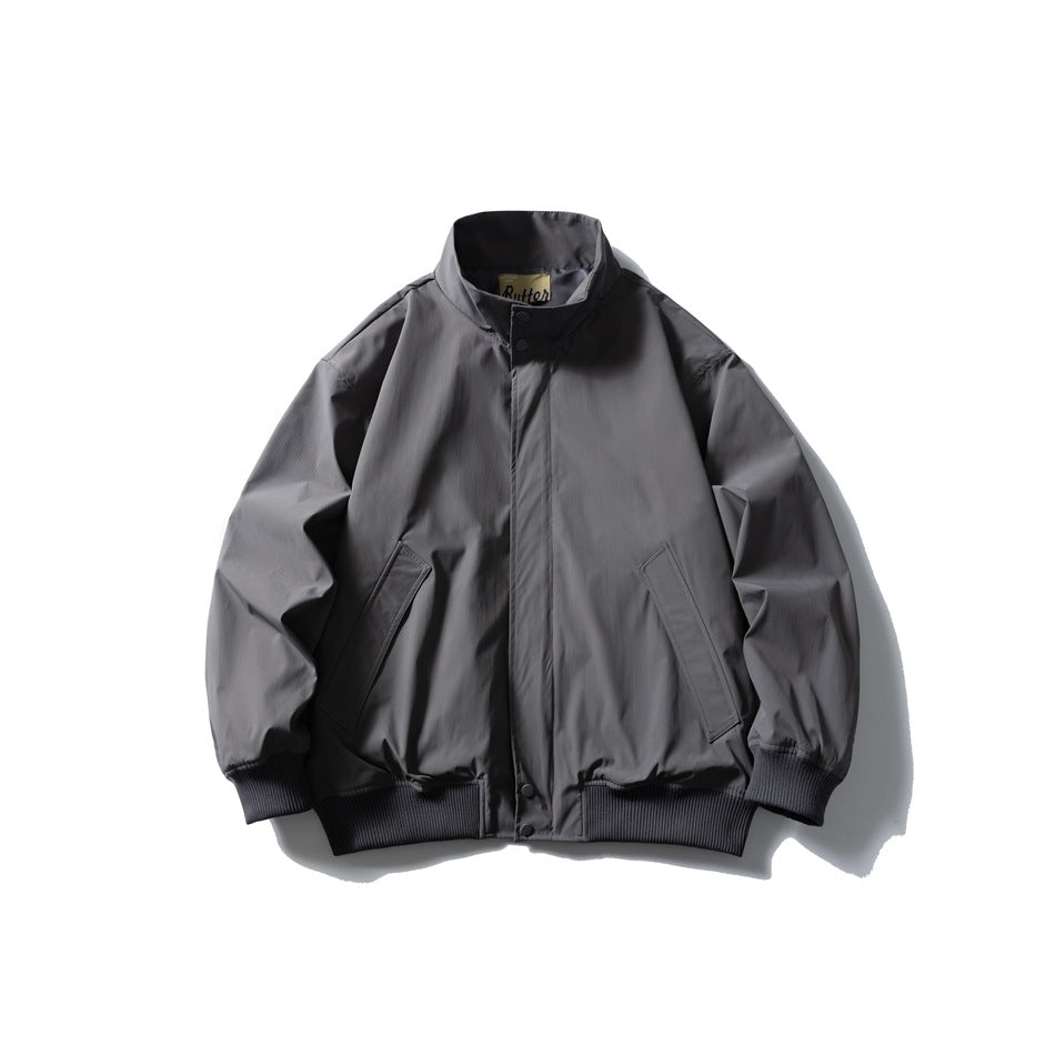 Gray stand-collar jacket flat lay front view with snap placket, angled pockets and ribbed cuffs and hem