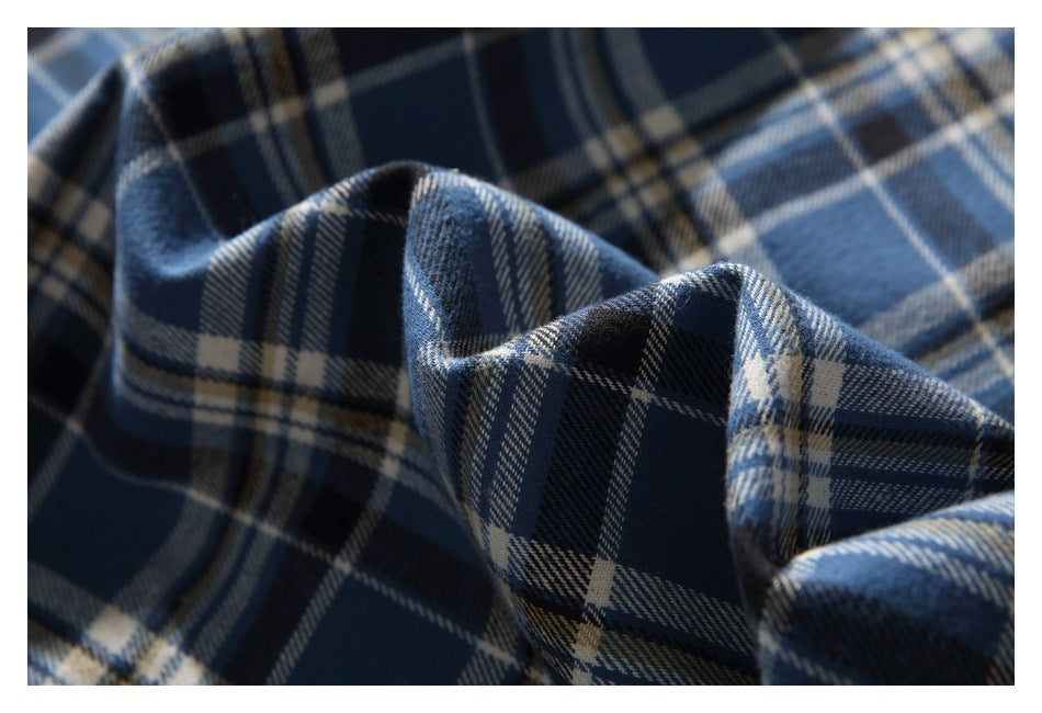 Close-up of blue and navy plaid fabric folded to show its check pattern.