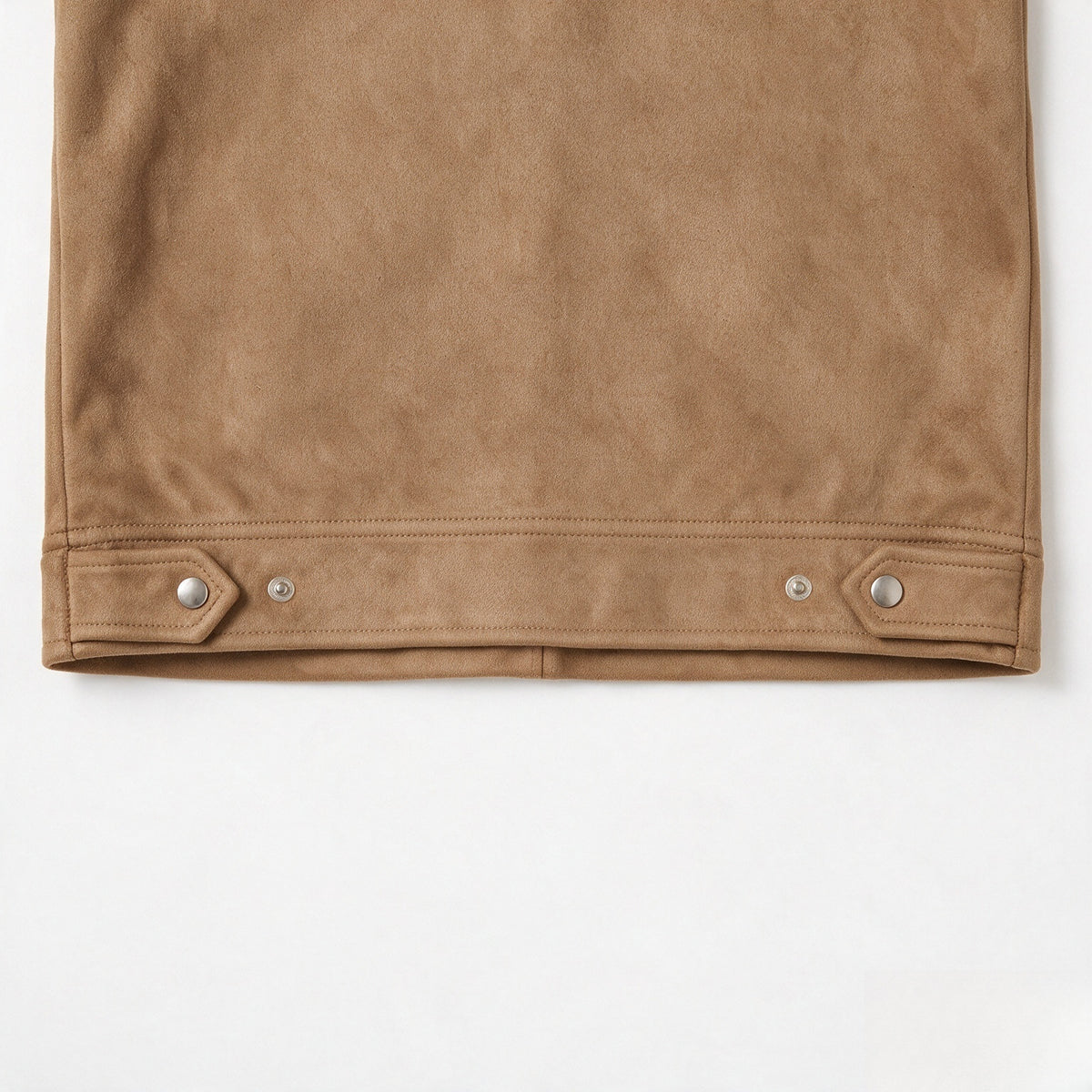 Close-up of the tan jacket’s bottom hem with adjustable snap-tab details.