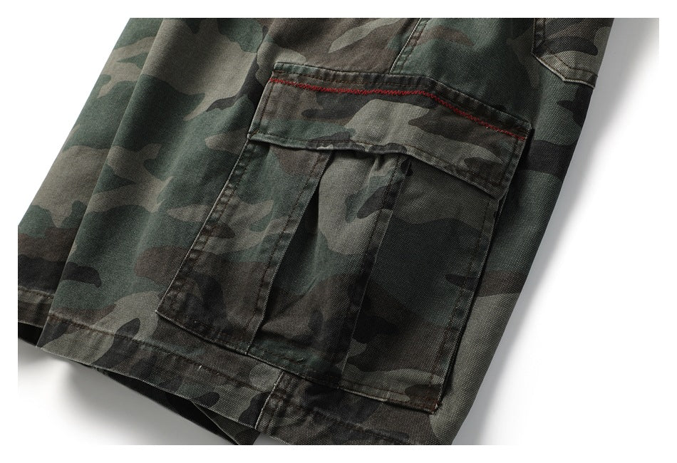 Close-up of a camouflage cargo pocket with contrasting red stitching.