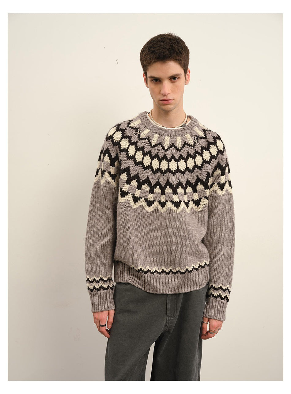 Closer front view of a model wearing a taupe crew-neck sweater with a dark and cream Fair Isle yoke.