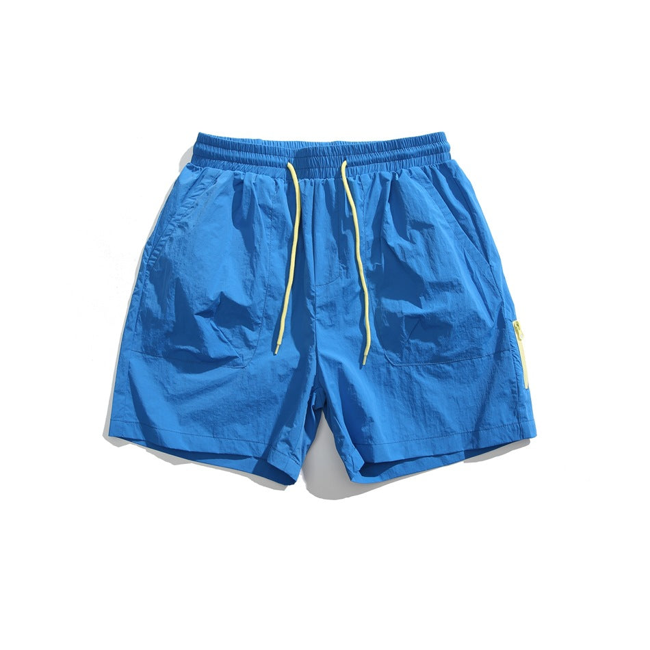 Royal blue drawstring shorts with yellow cord, front patch pockets and side zipper, flat lay front view