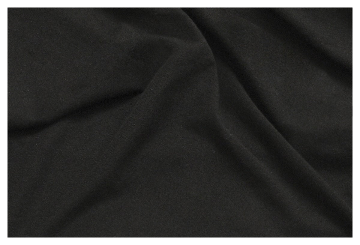 Close-up of plain black fabric draped into soft folds.